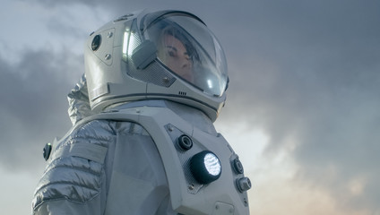 Shot of Female Astronaut in the Space Suit Looking Around Frozen Alien Planet. Advanced...