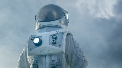 Shot of the Brave Astronaut in the Space Suit Looking Around Alien Planet. Blue and Cold Planet....