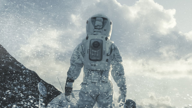 Shot of the Astronaut Walking Through Blizzard on Frozen Alien Planet Towards His Base/ Research Station. Technological Advance Brings Space Exploration, Colonization.