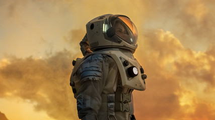 Shot of Female Astronaut in the Space Suit Looking Around Alien Planet. Red and Orange Planet Similar to Mars. Advanced Technologies, Space Travel, Colonization Concept.