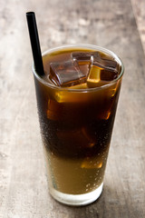 Iced coffee in glass on wooden table. 