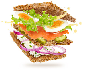 salmon and eggs sandwich floating isolated on white background