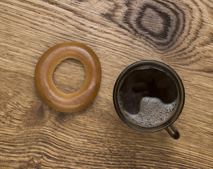 brown mug with hot coffee on wood background