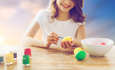 close up of girl coloring easter eggs