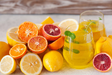 Fototapeta na wymiar Detox citrus water, refreshing summer homemade lemonade cocktail with lemon and orange