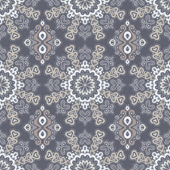 Abstract seamless pattern of dots and curls.