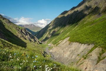 Landscape of a mountain valley with view at mountain river and mountain range.