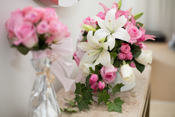 Romantic flower decoration in an hotel room for a couple in love. White flowers with pink roses. Valentines Day Concept. Beautiful flower bouquet.