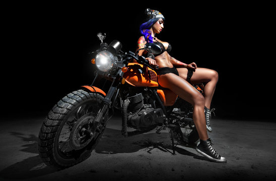 Stylish motorcycle chopper with sexy tattoed chick rider at night