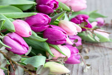 bouquet of pink and violett tulips  / beautiful bouquet of pink and violet tulips on a wooden background © Cora Müller