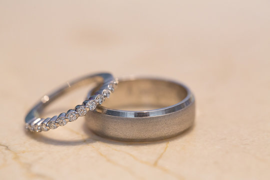 Concept together till death do us part. Closeup of bride and grooms wedding rings with light background. Love symbol. Copy space.