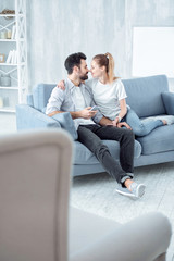 Look at me. High-spirited young people sitting close to each other and keeping eyes closed while touching noses
