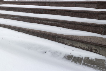 Granite brown stairs under the white snow