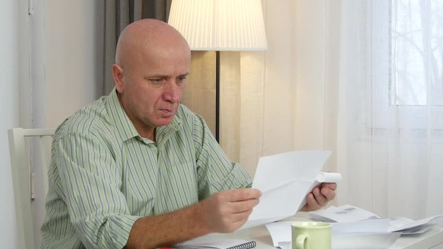 Businessman Looking in Accounting Papers Calculate Profit Use Adding Machine