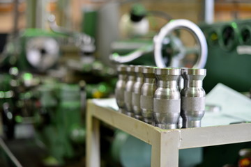 Turning products from metal on the rack against the background of the machine. Details with a notch on the side.