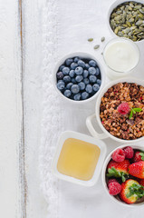 Healthy breakfast with granola, berries and youghurt on white
