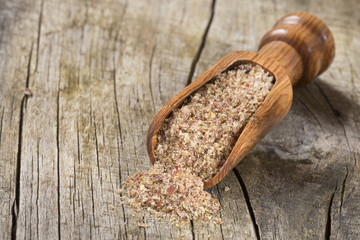 Ground flaxseed in the spoon - Linum usitatissimum