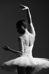 Naklejka premium Young beautiful ballerina is posing in studio