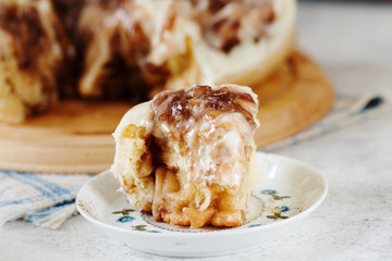 Homemade cinnamon roll with cream sauce on the plate
