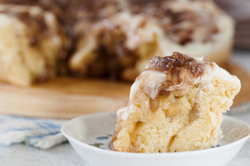 Homemade cinnamon roll with cream sauce on the plate