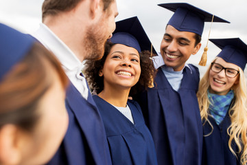 happy students or bachelors in mortar boards