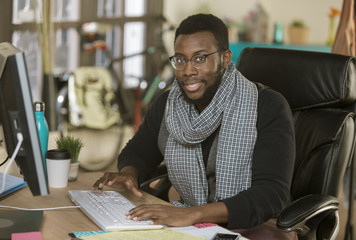 Fototapeta premium Handsome Creative Business Man in an Office at Keyboard