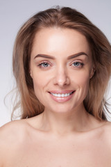closeup portrait of beautyful blond smiling woman with clean fresh skin