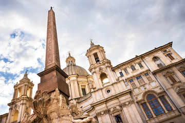 Fototapeta na wymiar Rome - Church Sant Agnese in Agone and Fountain of the four Rivers with Egyptian obelisk on Piazza Navona in Rome, Ital