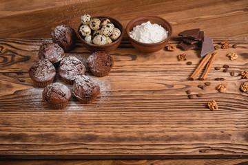 chocolate muffins on a wooden table