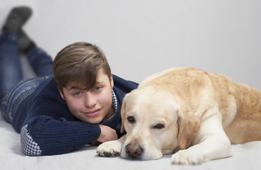 teenager boy and yellow labrador