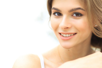 closeup portrait of a smiling young woman with light make-up