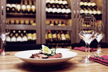 Roast beef appetizer on table, toned