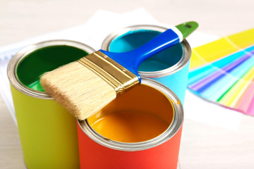 Paint cans and brush for interior decorating, closeup