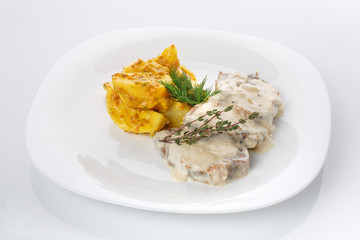 Delicious lunch. Potatoes in French mustard with meat in mushroom sauce