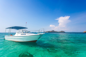Fototapeta na wymiar Yacht in the sea around the island on a background of blue sky , Thailand, Copy space.