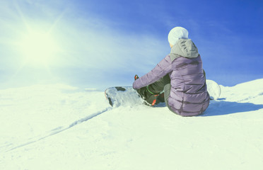 A snowboarder on the slopes on a sunny morning. Wearing device