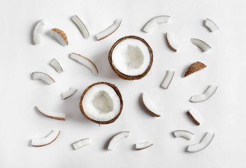 Ripe coconuts on white background, top view
