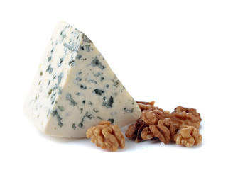 Wedge of soft blue cheese with walnuts isolated on white.