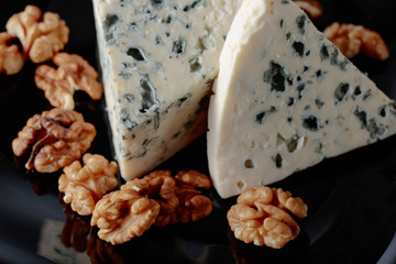 Wedges of soft blue cheese with walnuts.