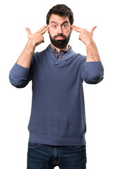 Handsome brunette man with beard making suicide gesture on white background