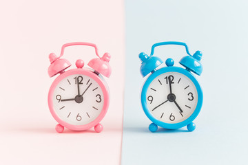 Alarm clocks on pastel background minimalistic concept.