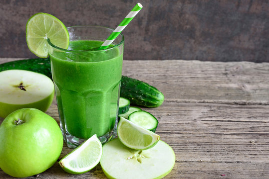 Green Smoothie In A Glass With Spinach, Apple, Cucumber And Lime With A Straw. Detox Drink