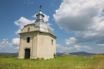 Fototapeta na wymiar Spisska Kapitula - Chapel over the st. Martins cathedral and riuns of Spissky castle in the backgound.