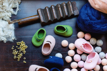 Fototapeta na wymiar Tools and material for working with merino wool. Creation of children's shoes made of wool.