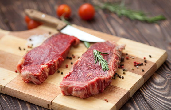raw steak on cutting board
