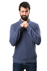 Handsome brunette man with beard fighting on white background