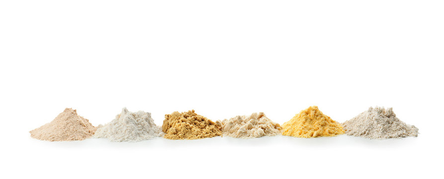 Different types of flour on white background