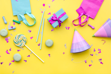 Gift box and colorful paper bag on yellow background top view space for text