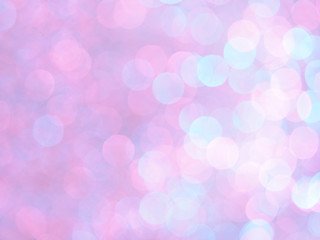 Bright and abstract blurred pink,light blue, violet and white background with shimmering glitter. Defocused unique bokeh festive lights. Colorful bright light texture of circular points