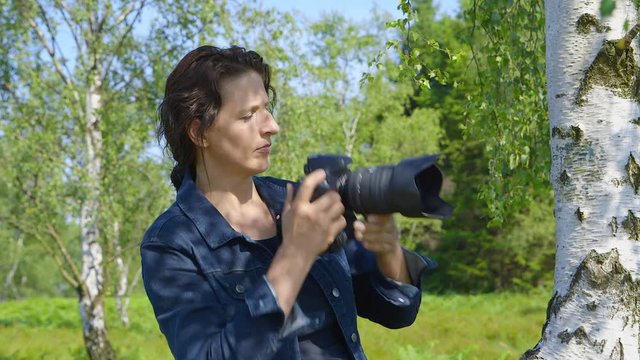 Professional nature photographer, taking pictures, using a digital SLR camera - ProRes